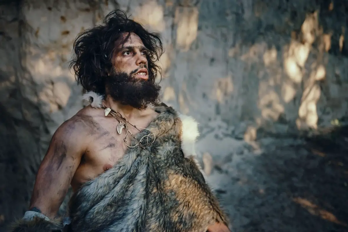 Portrait of primeval caveman wearing an animal skin.
