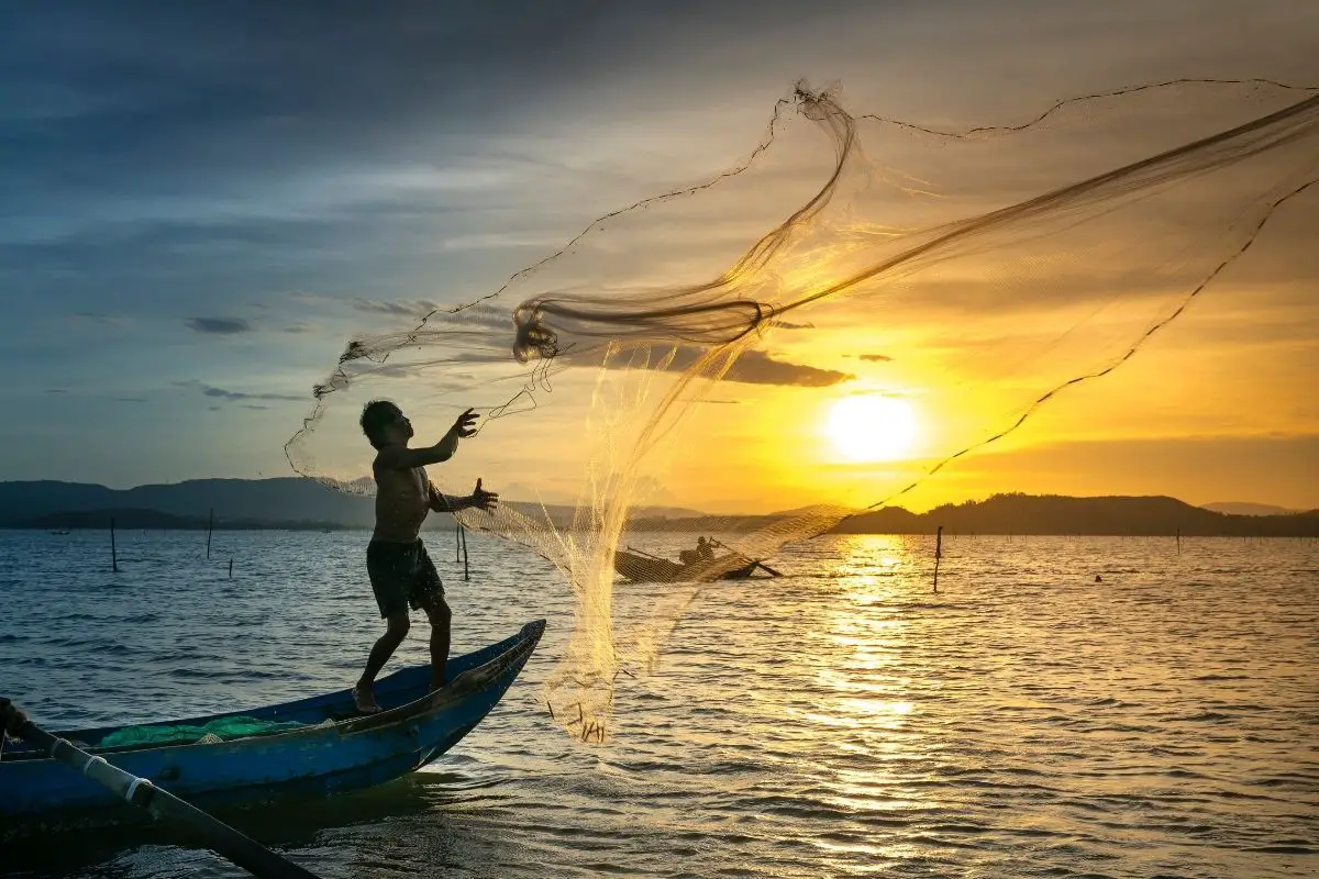 A man throwing his fishing nets in the sea.